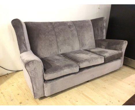 A contemporary grey sofa with wing back high back, on castors, (97cm x 190cm x 97cm)