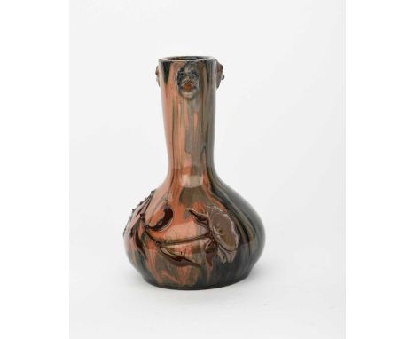 A Sunflower Pottery vase by Sir Edmund Elton, ovoid with cylindrical neck, applied with masks, the vase with applied foliage 