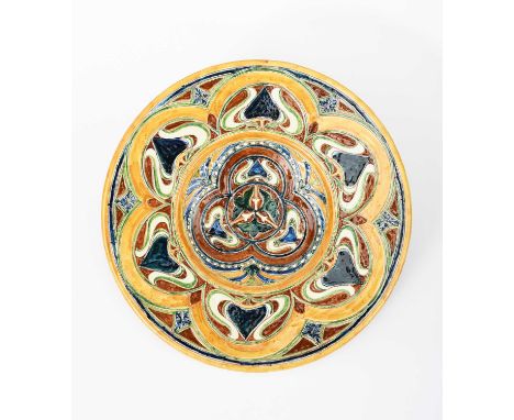 A Della Robbia Pottery charger by Annie Smith, incised and painted with radiating Art Nouveau flower stems, the rim with simi