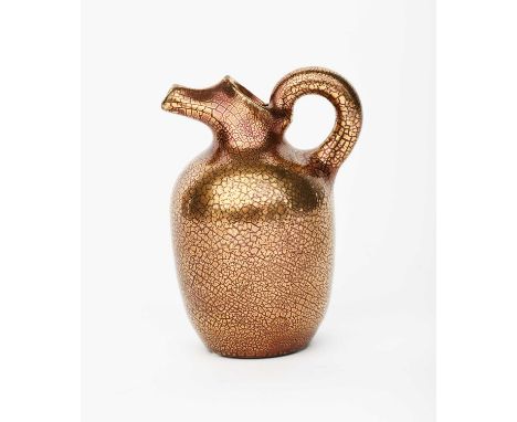 A Sunflower Pottery ewer by Sir Edmund Elton, shouldered form, with tube spout, covered in a crackled gold glaze painted Elto