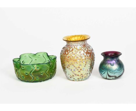 A Loetz glass vase, shouldered ovoid form with flaring top rim, textured with golden iridescence, and two other iridescent gl