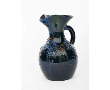 A Sunflower Pottery ewer by Sir Edmund Elton, ovoid with flaring neck, applied with a band of stylised flowers and foliage in