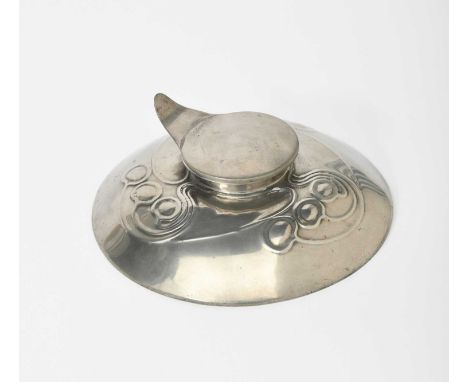 A Liberty &amp; Co Tudric Pewter inkwell designed by Archibald Knox, model no.0211, flat, circular form cast in low relief wi