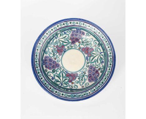 A Carter Stabler & Adams Poole Pottery Grape charger designed by Truda Adams, pattern VA, painted with a frieze of grape vine