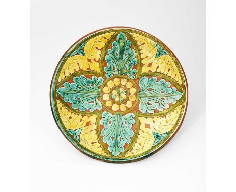 A Della Robbia Pottery small charger by Hannah Jones, incised and painted with radiating leaves in turquoise and yellow on a 