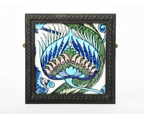 A William De Morgan Late Fulham Period Persian tile, painted with a palmette and flower design in blue, turquoise, aubergine 
