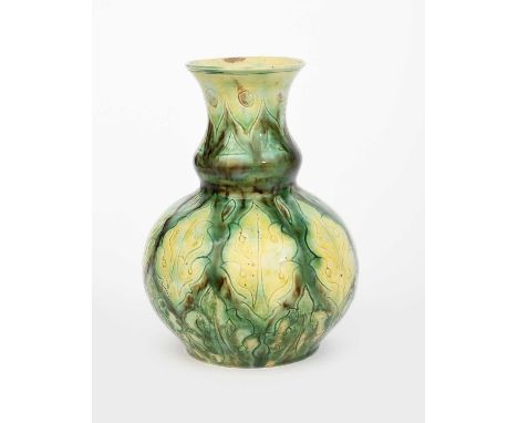 A Della Robbia Pottery vase by Hannah Jones and Charles Collis, ovoid with swollen neck, incised with vertical foliate panels