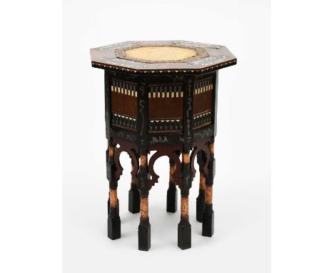 A Bugatti walnut Moorish table designed by Carlo Bugatti, octagonal section, with single, hinged door compartment, on arched 
