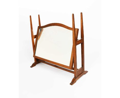 An Arthur W Simpson's of Kendal oak dressing table mirror in the manner of Charles Francis Annesley Voysey, the arched, recta