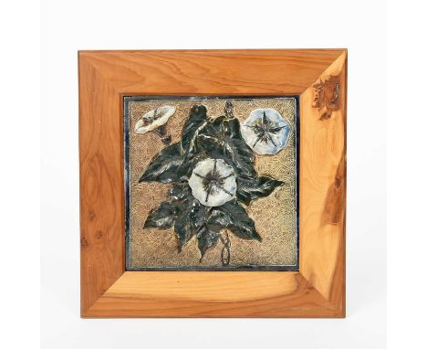 A Martin Brothers stoneware tile by Robert Wallace Martin, modelled in low relief with convolvulus flowers, glazed green, blu