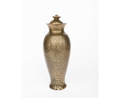 A tall Sunflower Pottery vase and cover by Sir Edmund Elton, slender, shouldered form with thin ribs, covered in a crackled g