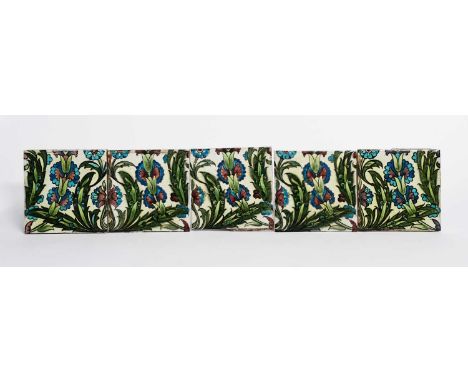 Five William De Morgan Sands End Pottery Persian tiles, each painted with flowers and foliage in blue, green and aubergine on