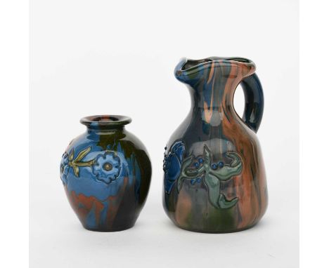 A Sunflower Pottery jug by Sir Edmund Elton, shouldered form, with applied flower stem in green and blue on a streaked blue a
