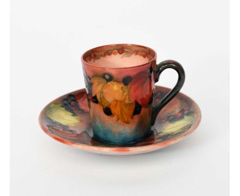 'Flambe Leaf and Berry' a Moorcroft Pottery coffee can and saucer designed by William Moorcroft, painted in colours under a f