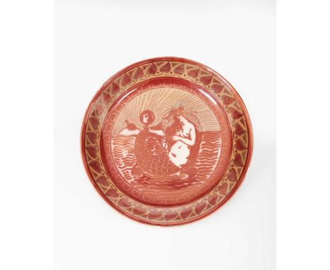 A William De Morgan pottery charger, painted to the well with a mermaid holding a hand mirror, inside a leaf border, glazed i