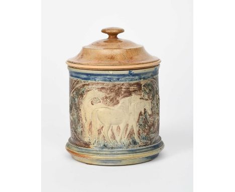 An early Martin Brothers stoneware caddy by Robert Wallace Martin, cylindrical form, modelled in low relief with panels of ho