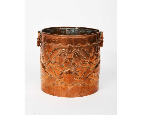 A large Newlyn Industrial Classes copper ice bucket, cylindrical with applied twist handles, the body hammered in relief with