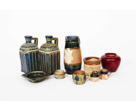 A pair of Doulton Lambeth stoneware Whisky and Brandy flasks, shouldered, square section applied foliate decoration to the sh