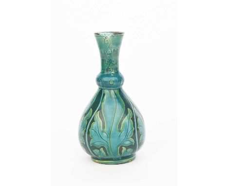 A Della Robbia Persian vase by John Fogo, ovoid with knopped garlic neck, incised with panels of stylised foliage, glazed tur