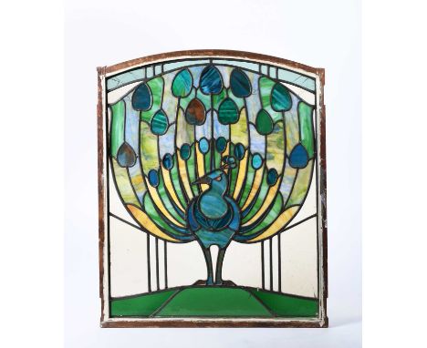 A stained glass Peacock window, rectangular with rounded top, decorated with a peacock displaying tail feathers, unsigned, 73