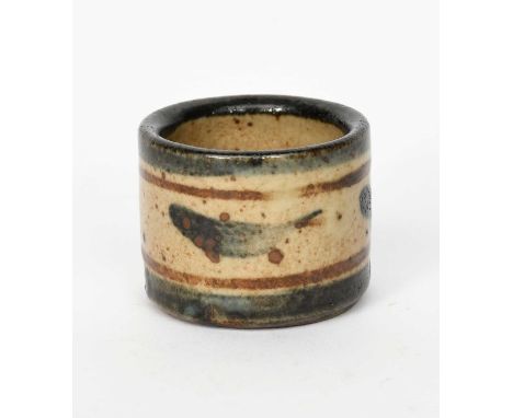 Bernard Leach CBE (1887-1979), attributeda Leach Pottery stoneware egg cup, painted with simple fish in blue and brown on a s