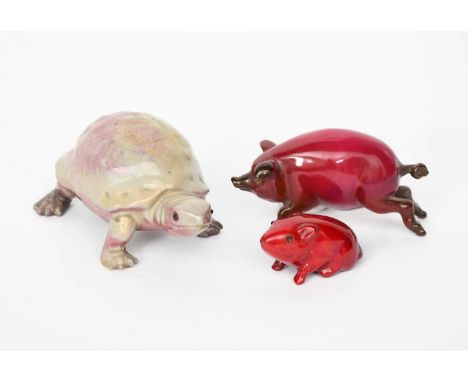 A Bernard Moore porcelain model of a tortoise, flambe glazed under grey, with applied glass eyes, a flambe model of a guinea 