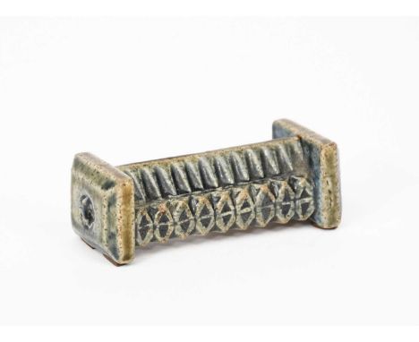 A Martin Brothers stoneware knife-rest by Robert Wallace Martin, dated 1881, modelled with geometric panels, in green and blu