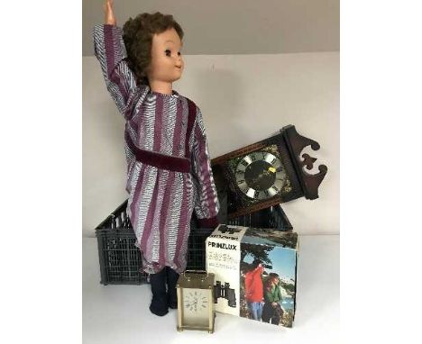 A crate of Perinzlux binoculars, projector, thirty-one day wall clock, carriage clock, mid twentieth century doll, five frame