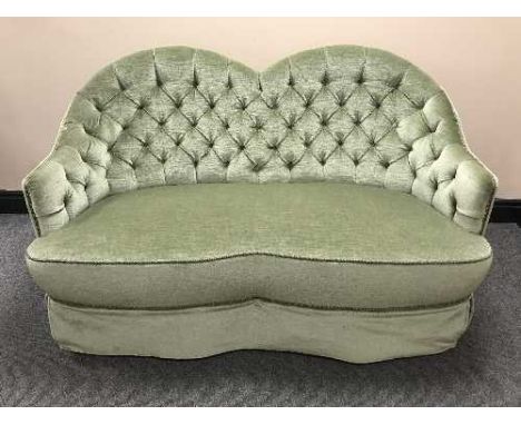 A shaped green button dralon two seater settee 