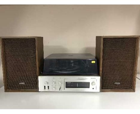 An Onkyo turn table amplifier with speakers together with a box of lps and 45's 