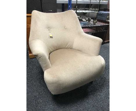 A  button back bedroom chair in beige fabric 