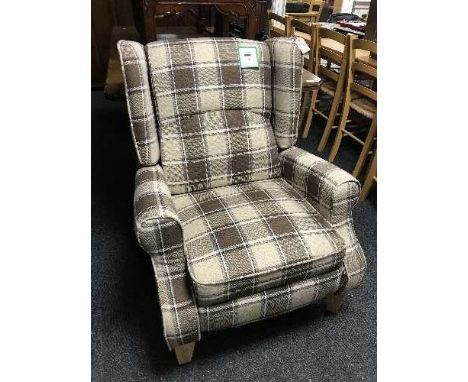 A contemporary reclining armchair in a brown checked print 