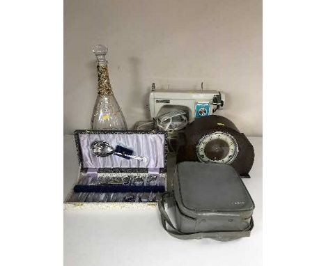 A cased Newholme electric sewing machine together with an oak Bentime mantel clock, large glass decanter with stopper etc 