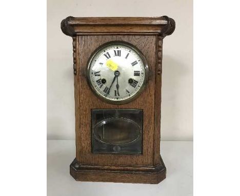 An Edwardian oak mantel clock with silvered dial 