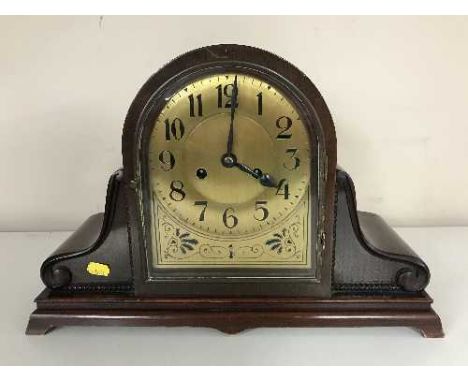 An early twentieth century mahogany domed mantel clock with brass dial