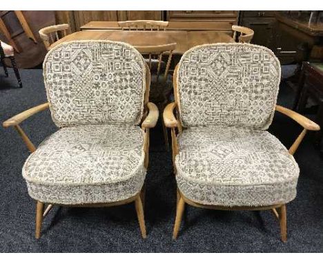 A pair of elm Ercol armchairs 