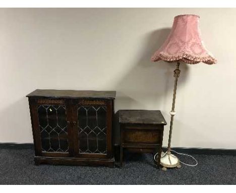 A leaded door bookcase, a sewing box and a standard lamp with shade 