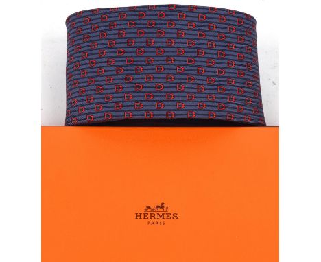 HERMES Three silk ties on a wooden rack and an Hermes tie boxCondition Report:  Good condition