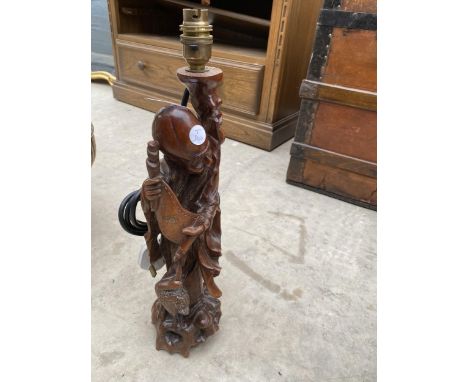 A WOODEN CARVED TABLE LAMP DEPICTING A TRIBAL MAN 