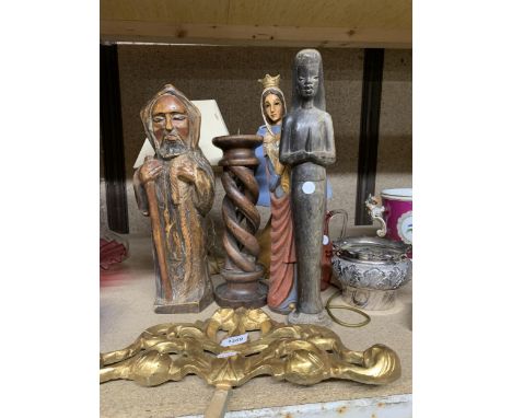 A MIXED LOT TO INCLUDE RELIGIOUS CARVED FIGURES, A LARGE BARLEY TWIST WOODEN CANDLESTICK, TABLE LAMPS, A CRANBERRY GLASS JUG,