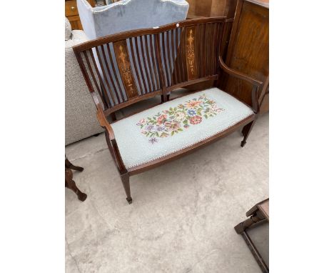 AN EDWARDIAN MAHOGANY AND INLAID TWO SEATER SETTEE WITH TAPESTRY SEAT, ON TAPERED LEGS, WITH SPADE FEET 