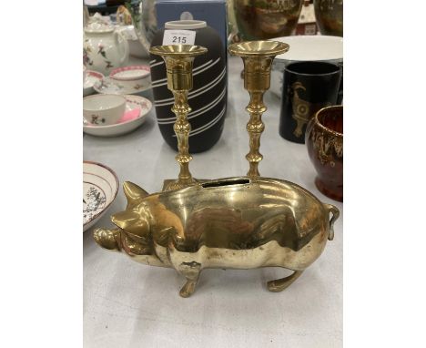 A PAIR OF VINTAGE BRASS CANDLESTICKS AND A BRASS PIG MONEY BOX 