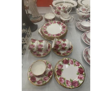 A ROYAL ALBERT 'OLD ENGLISH ROSE' TEASET TO INCLUDE A TEAPOT- SLIGHT RUB TO ONE ROSE - CAKE PLATE, SANDWICH PLATES, CREAM JUG