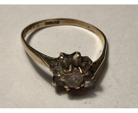 A 9 CARAT GOLD RING WITH CLEAR STONES IN A FLOWER DESIGN SIZE M/N GROSS WEIGHT 1.24 GRAMS 
