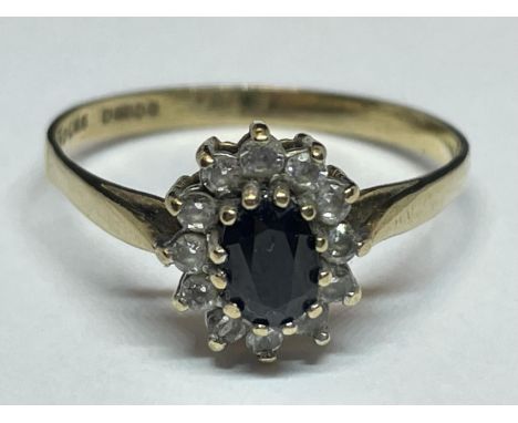 A 9 CARAT GOLD RING WITH A CENTRE SAPPHIRE SURROUNDED BY TEN CUBIC ZIRCONIAS SIZE S 