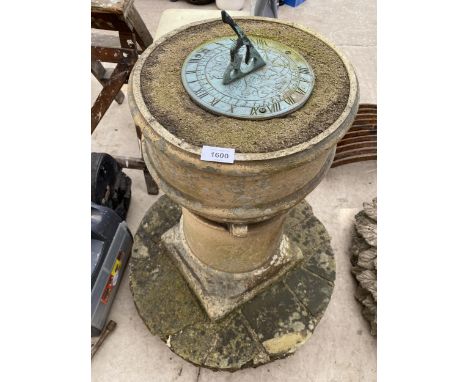 A STONE CHIMNEY POT SET ON A YORK STONE CRAZY PAVING PLINTH WITH A BRASS GNOMON SUNDIAL TOP 