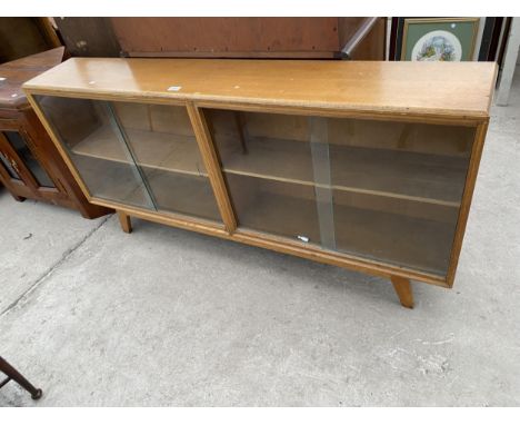 A MID 20TH CENTURY LIGHT OAK BOOKCASE WITH FOUR GLASS SLIDING DOORS, 60" WIDE 