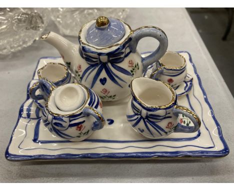 A MINIATURE CERAMIC TEASET ON A TRAY 