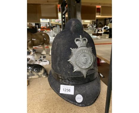 A VINTAGE STOKE ON TRENT CITY POLICE HELMET WITH PLATE 