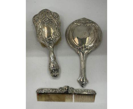 A GEORGE V SILVER BACKED THREE PIECE DRESSING SET COMPRISING HAND MIRROR, BRUSH AND COMB 